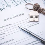 Rental agreement document with keys and pencil to illustrate a story on renting.
